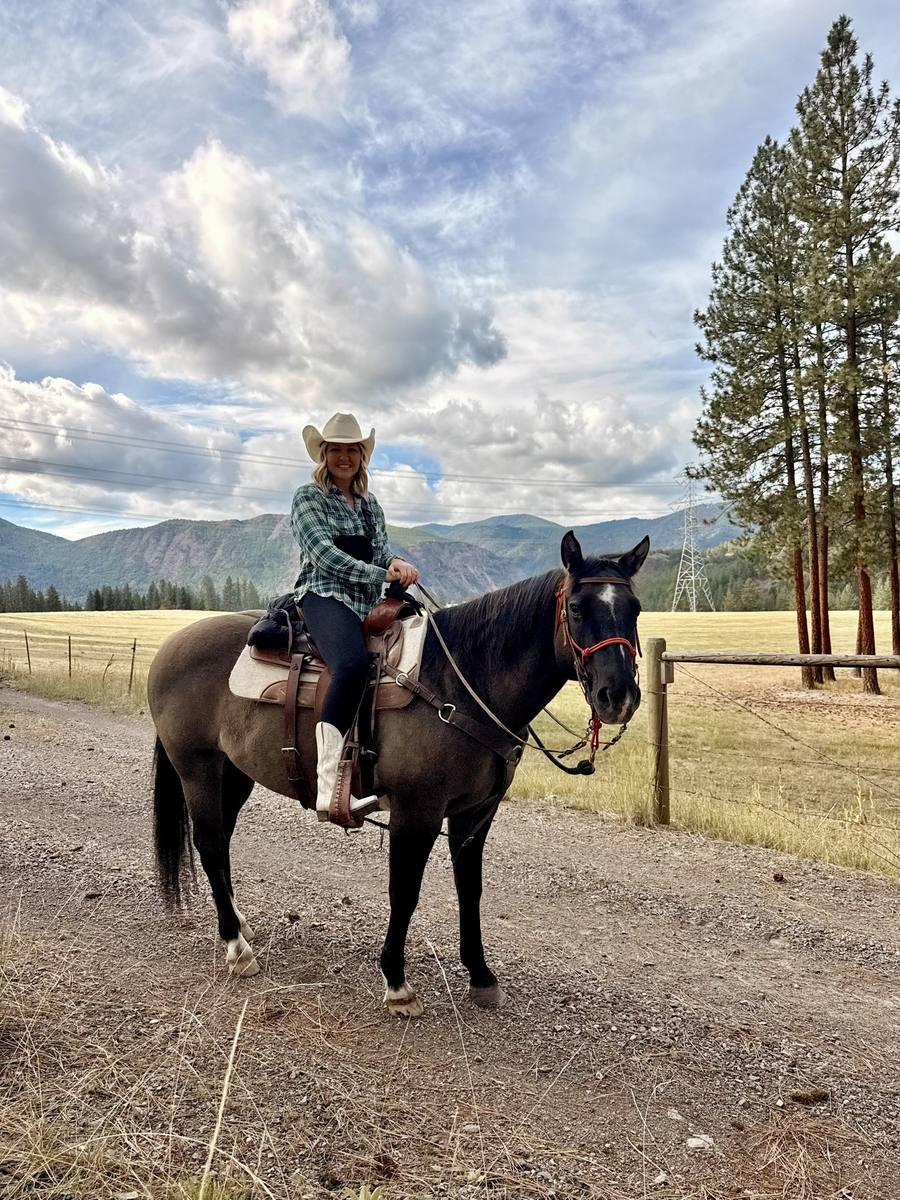 Adele in a cowboy hat with a horse at Riverview Ranch, Montana