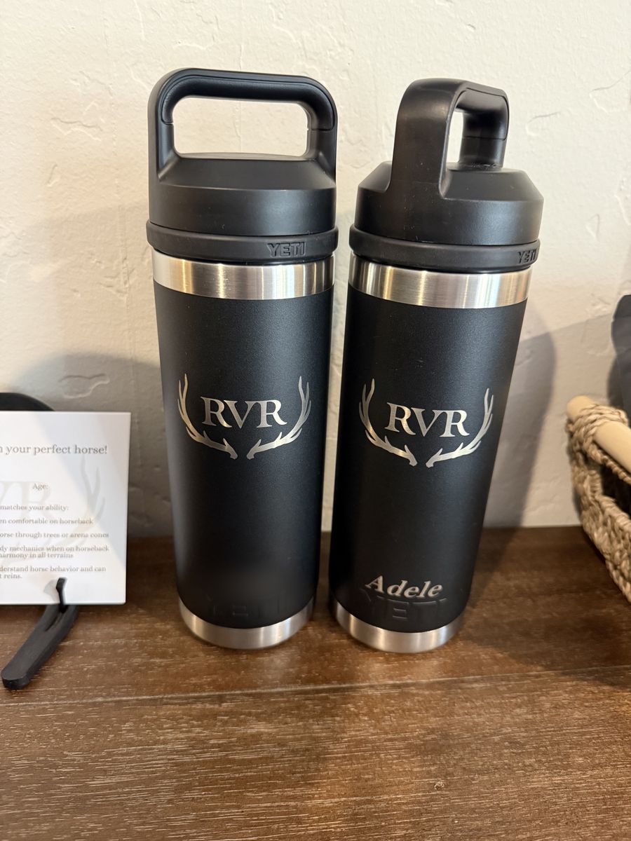 Two black RVR Yeti bottles engraved with names